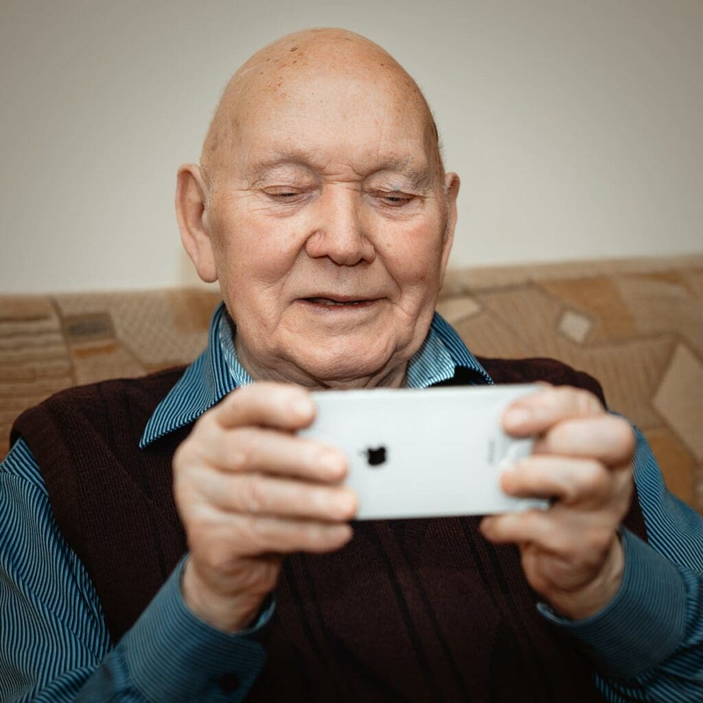 older man looking at phone screen