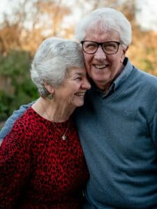 senior couple laughing with glasses
