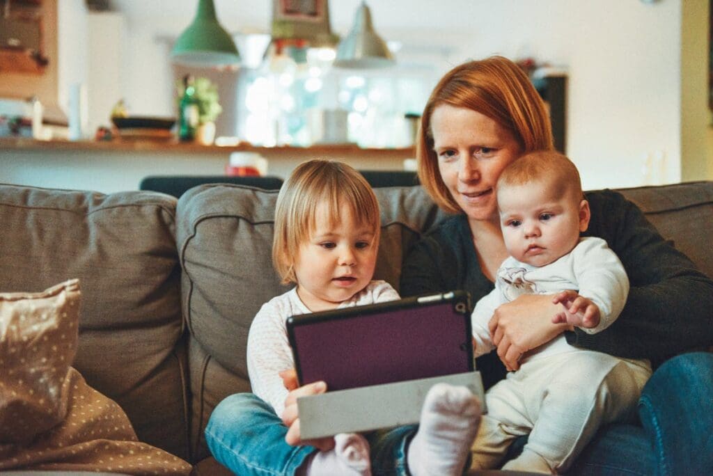 woman with children looking at table