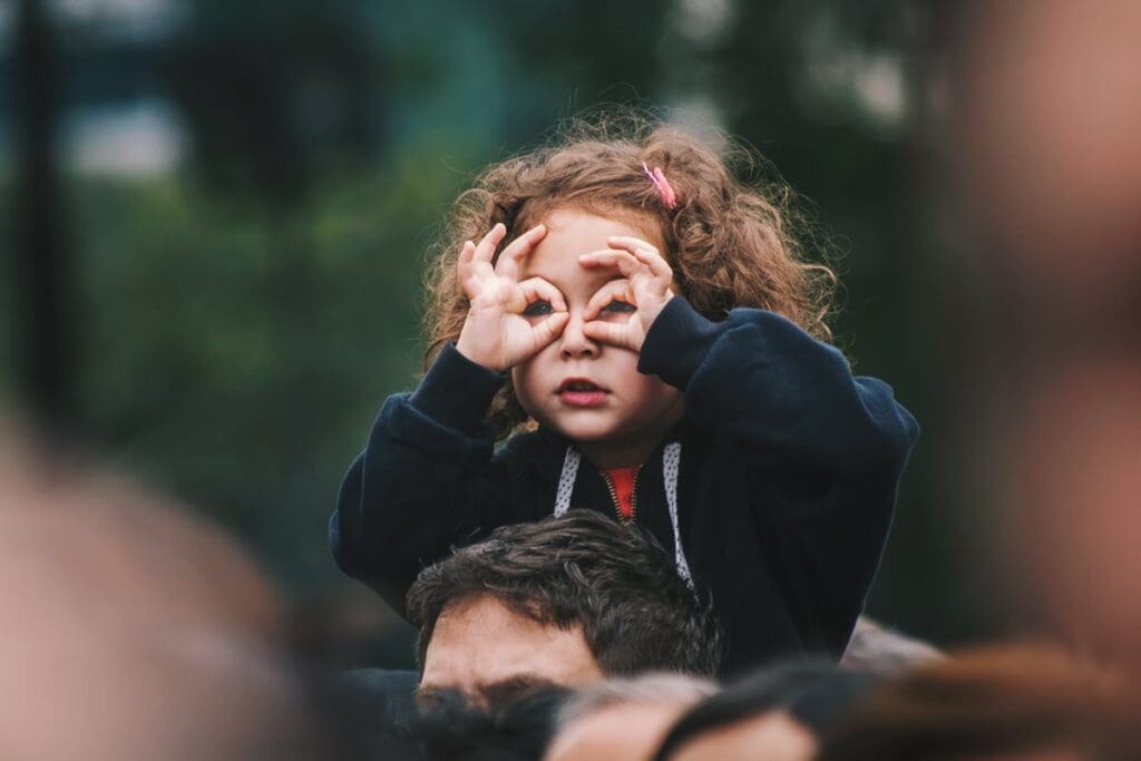 young girl on dad's shoulders