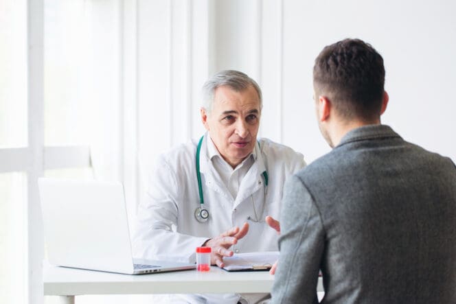 man speaking with doctor