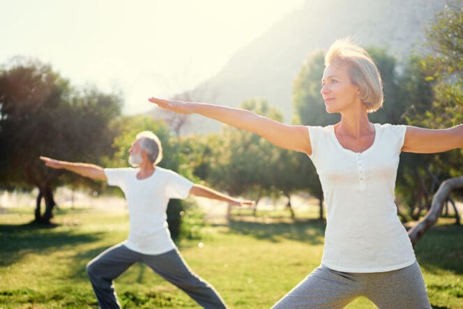 healthy older couple doing yoga