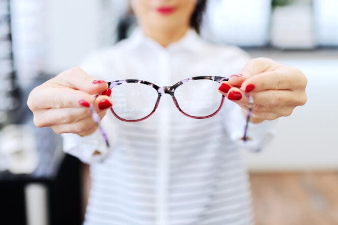 optician holding glasses