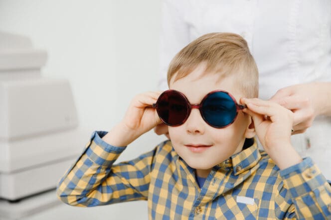 kid wearing colorblind glasses