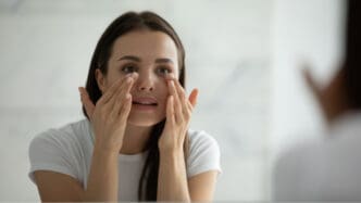 woman looking at veins under eyes