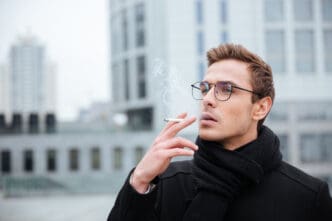 man in glasses smoking