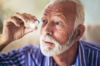 man using cataract eye drops