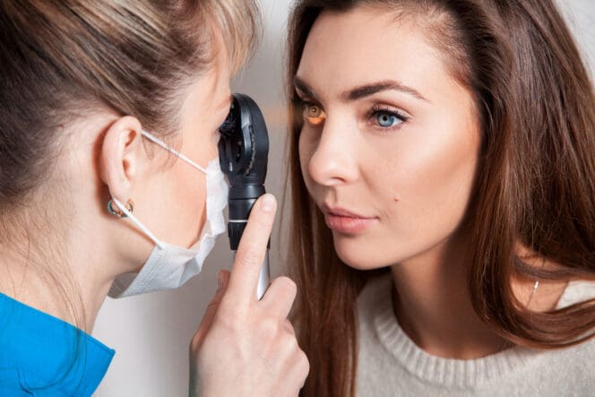 woman getting fuchs' dystrophy eye exam