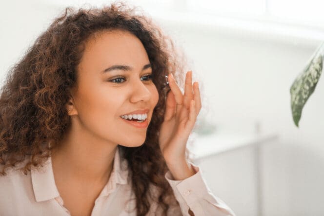 woman putting in contacts