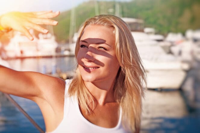 woman blocking eyes from sun